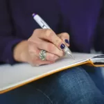 Free woman writing notebook