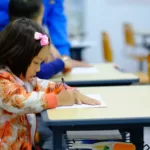 toddler sitting on desk